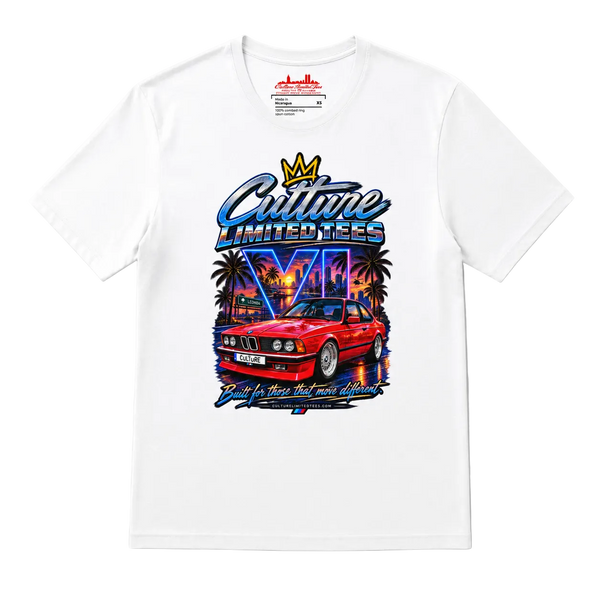 A white short-sleeve t-shirt with a colorful graphic print on the front. The graphic features a red classic car, palm trees, a neon cityscape, and stylized text reading 'Culture Limited Tees' with a crown above it.