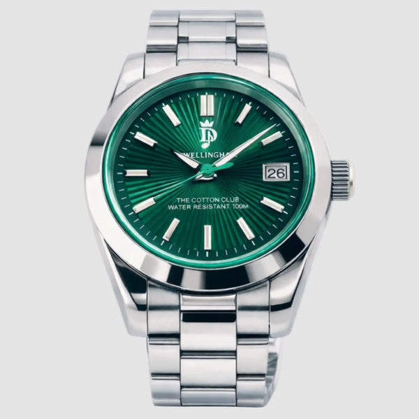 Silver watch with green dial on a white background, featuring 'The Cotton Club' branding.