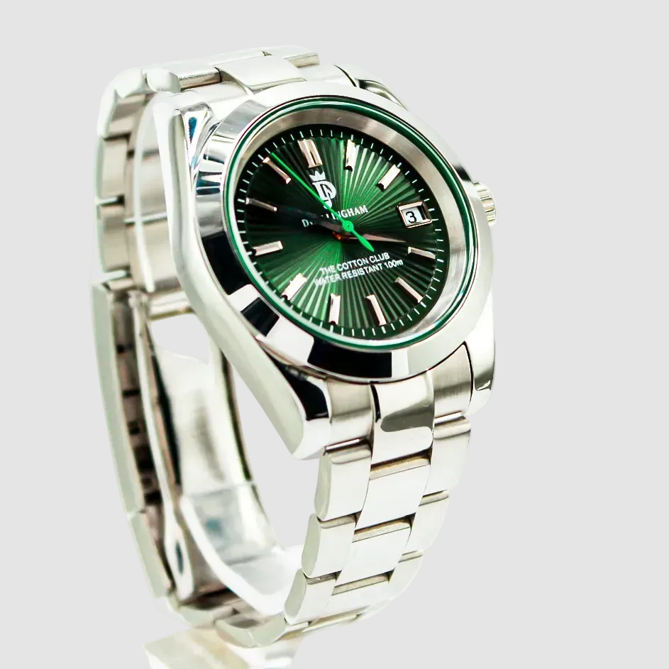 Silver watch with a green face on a white background