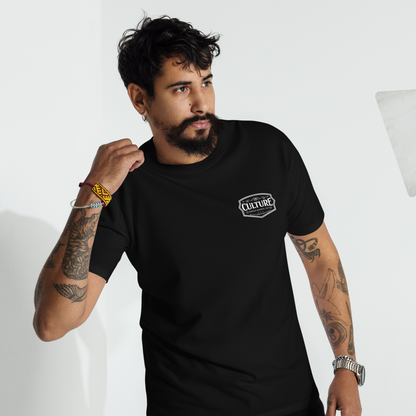 Man wearing a black t-shirt with a Culture Limited logo, standing in front of studio lighting equipment.